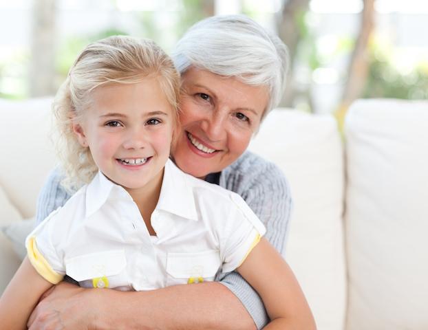 grandmother with dental implants holding her granddaughter in simi valley